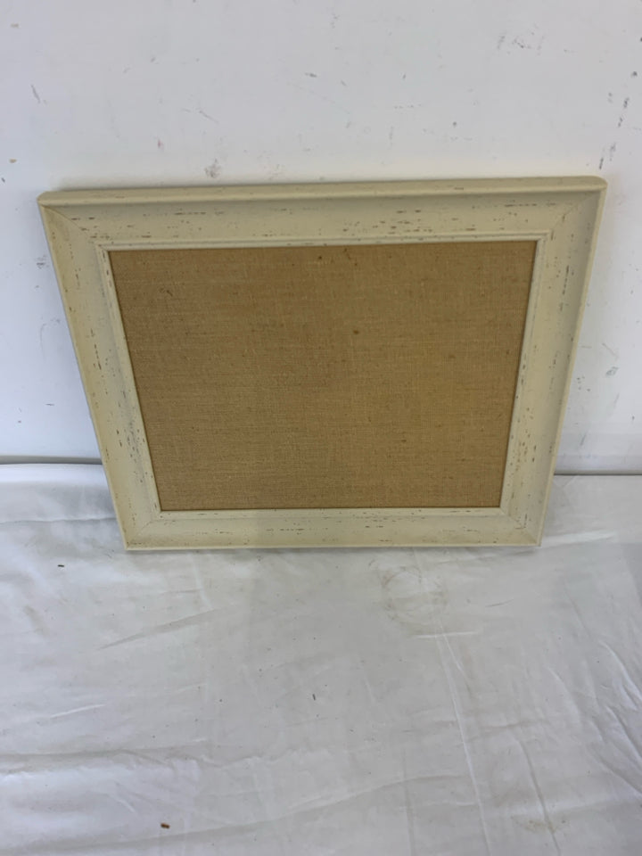 CREAM FRAMED CORK BOARD.