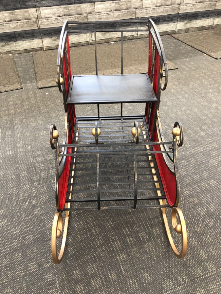 DISTRESSED METAL AND STAINED GLASS SLEIGH.