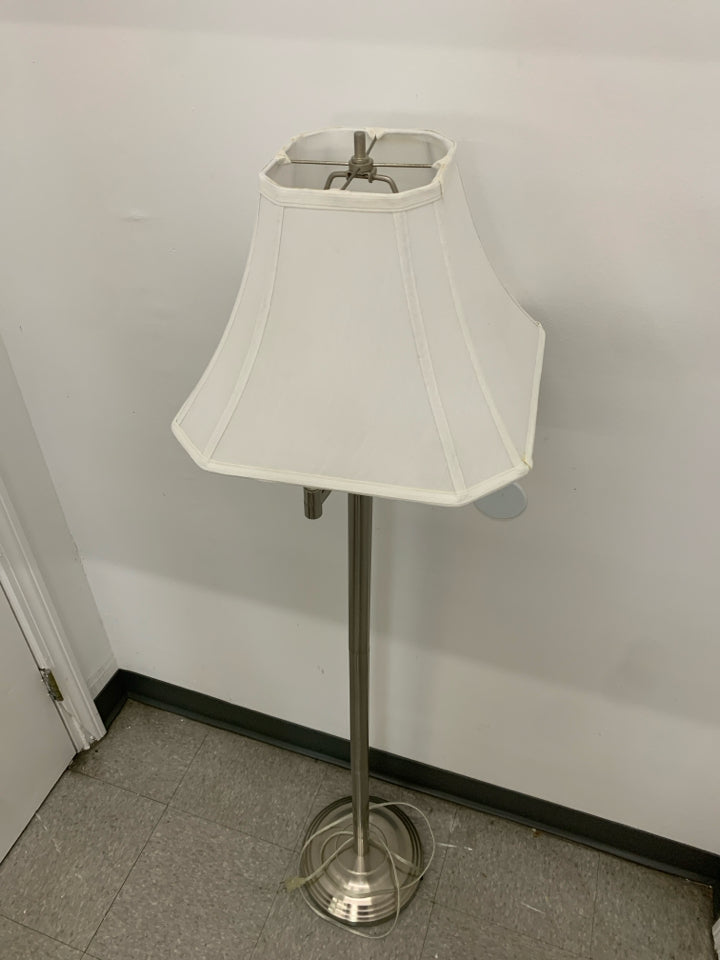 TALL SILVER FLOOR LAMP WITH WHITE SHADE.