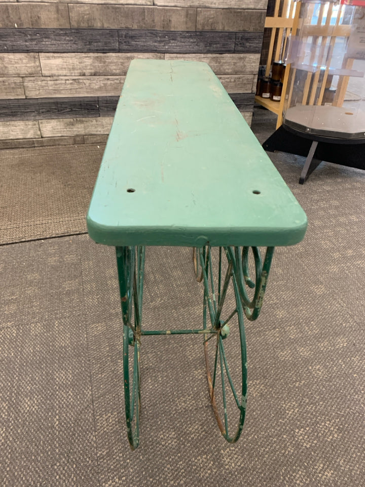 DISTRESSED RUSTIC PLANT STAND W/METAL WHEELS.