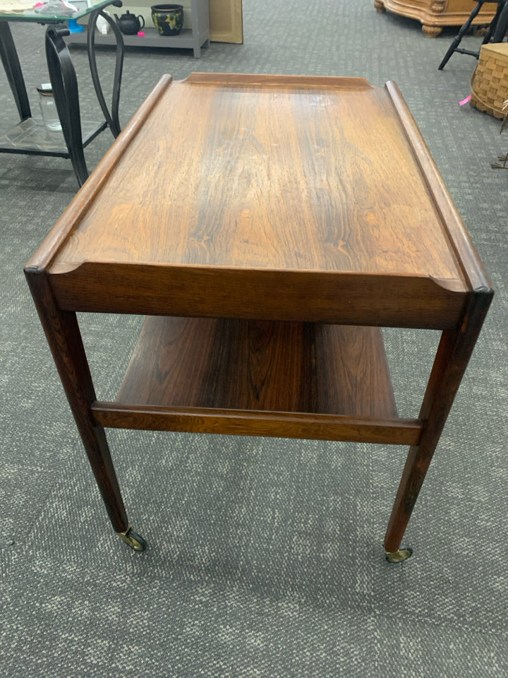 MADE IN DENMARK DARK WOOD MID CENTURY MODERN 2 TIER TABLE W/ WHEELS.