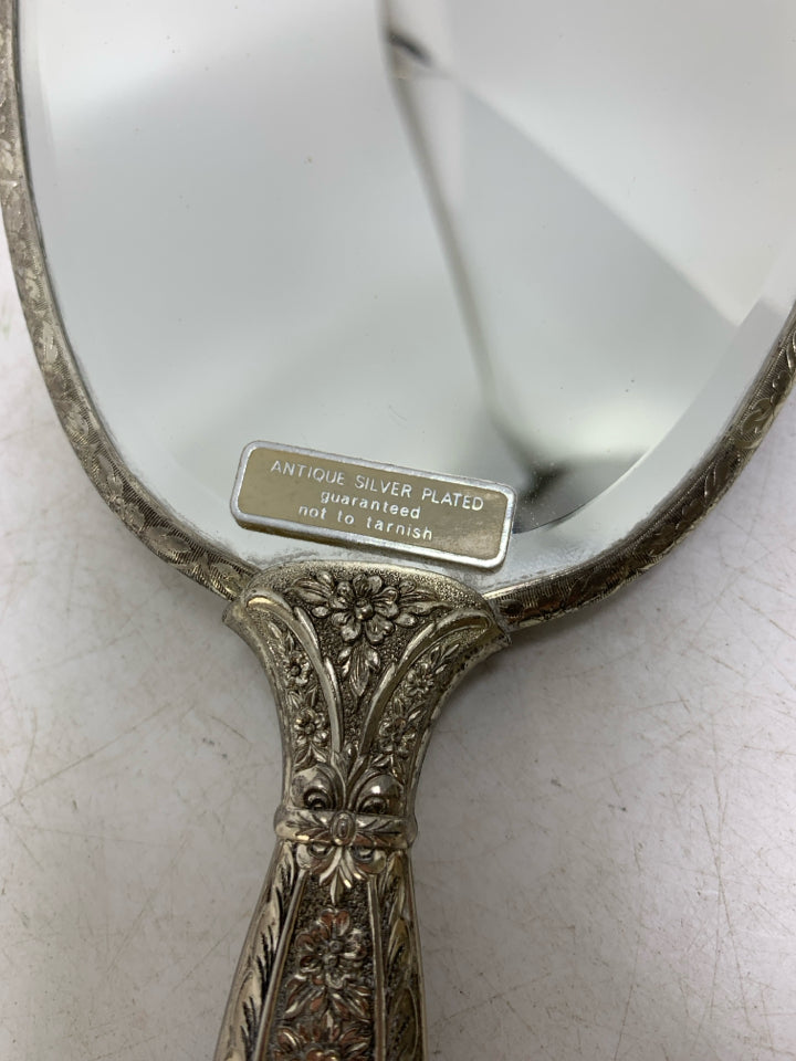 VTG SILVER PLATED HAND HELD MIRROR W/ EMBOSSED ROSE ON BACK.