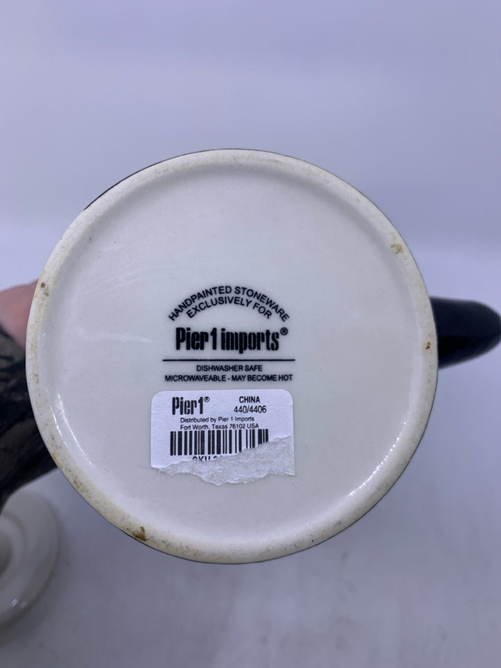 CREAM W/ MONKEY ON IT AND ARM AS HANDLE.