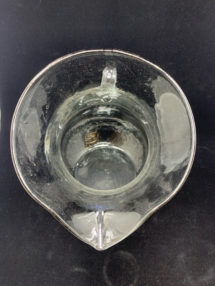 TILTED BLOWN GLASS PITCHER.