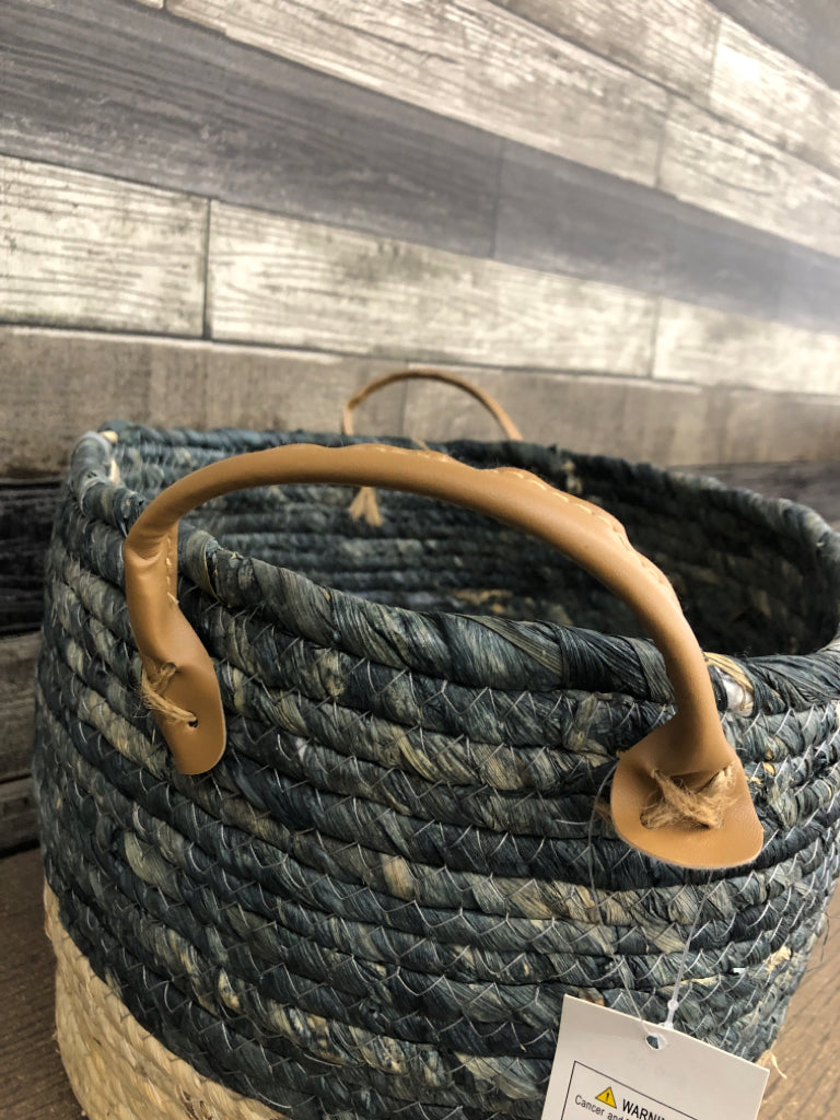 GRAY/BEIGE WOVEN BASKET W/FAUX LEATHER HANDLES.