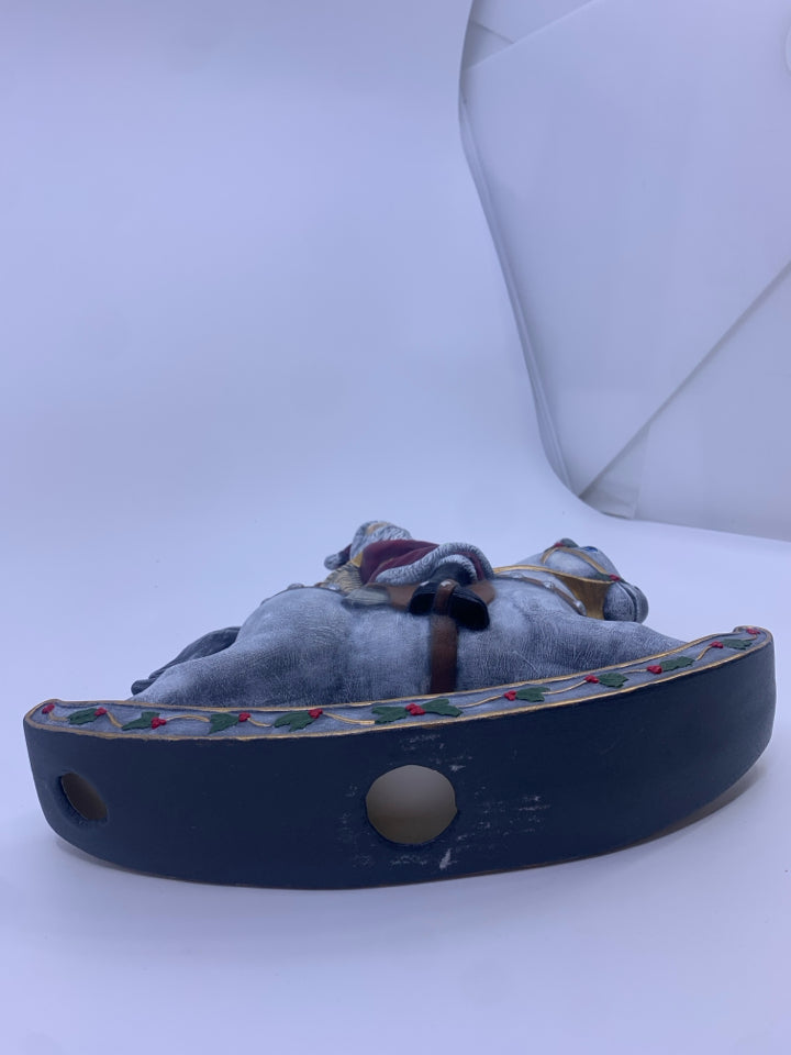 SANTA ON GRAY ROCKING HORSE.