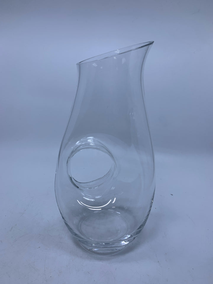 CLEAR GLASS PITCHER W/ CIRCLE HANDLE THROUGH CENTER.