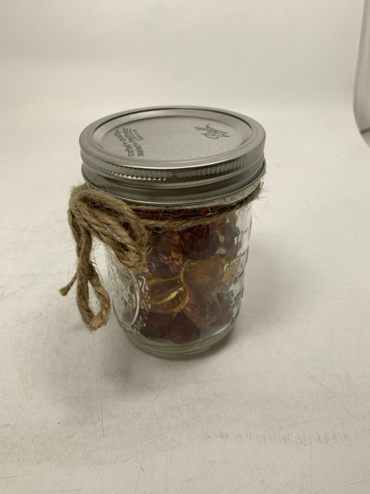 JAR OF PUMPKIN BEADS.