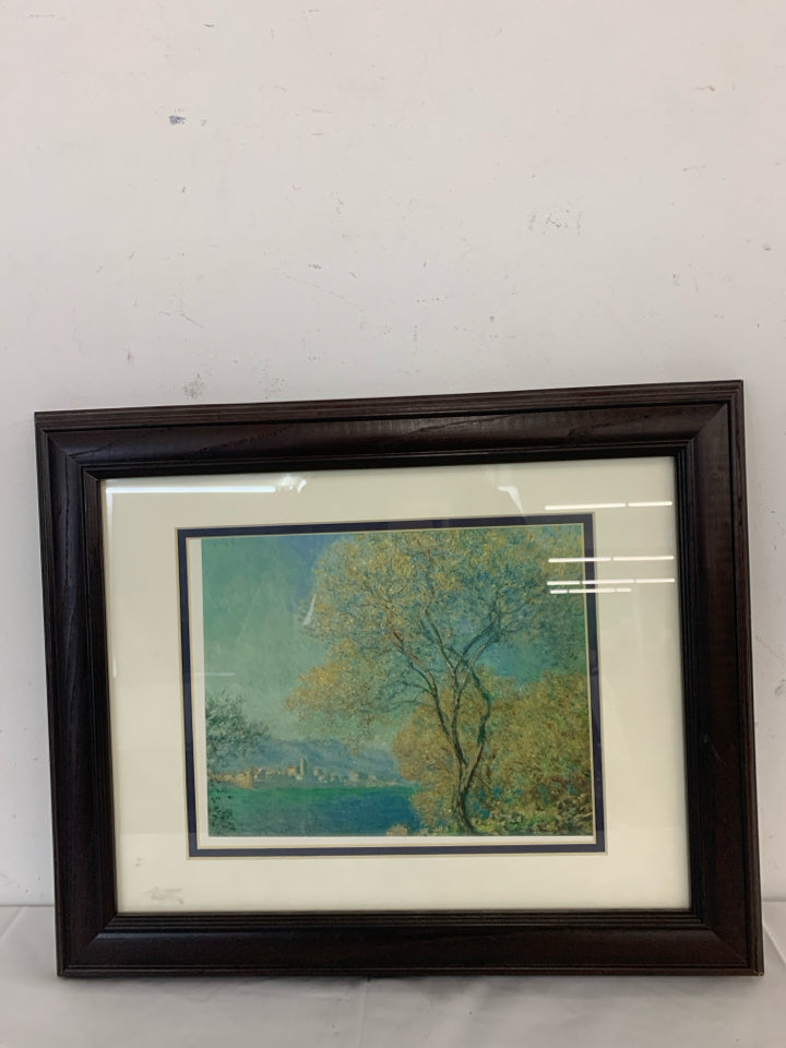 TREE CITYSCAPE WALL HANGING IN BROWN FRAME.