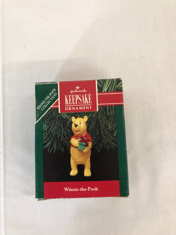 WINNIE THE POOH HOLDING HONEY ORNAMENT.