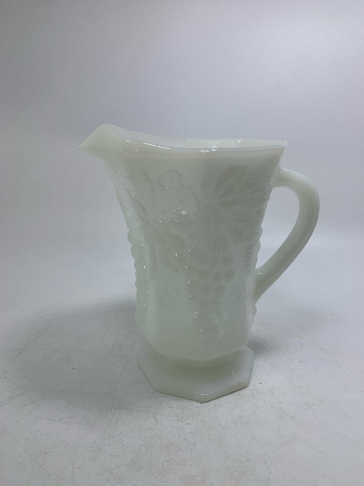 FOOTED MILK GLASS PITCHER W/ EMBOSSED GRAPES.