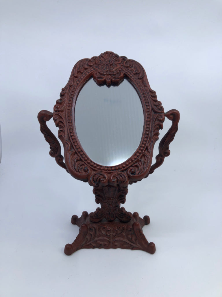 HEAVY RED METAL ORNATE MIRROR.
