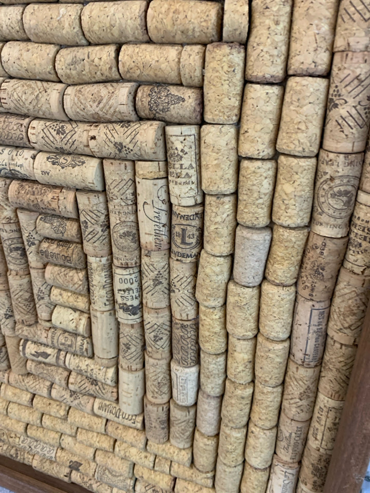 CORKS IN A BROWN FRAME.
