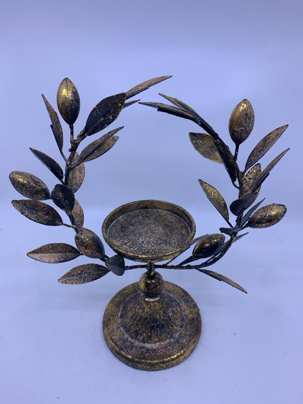 GOLD DISTRESSED CANDLE HOLDER WITH LEAVES.