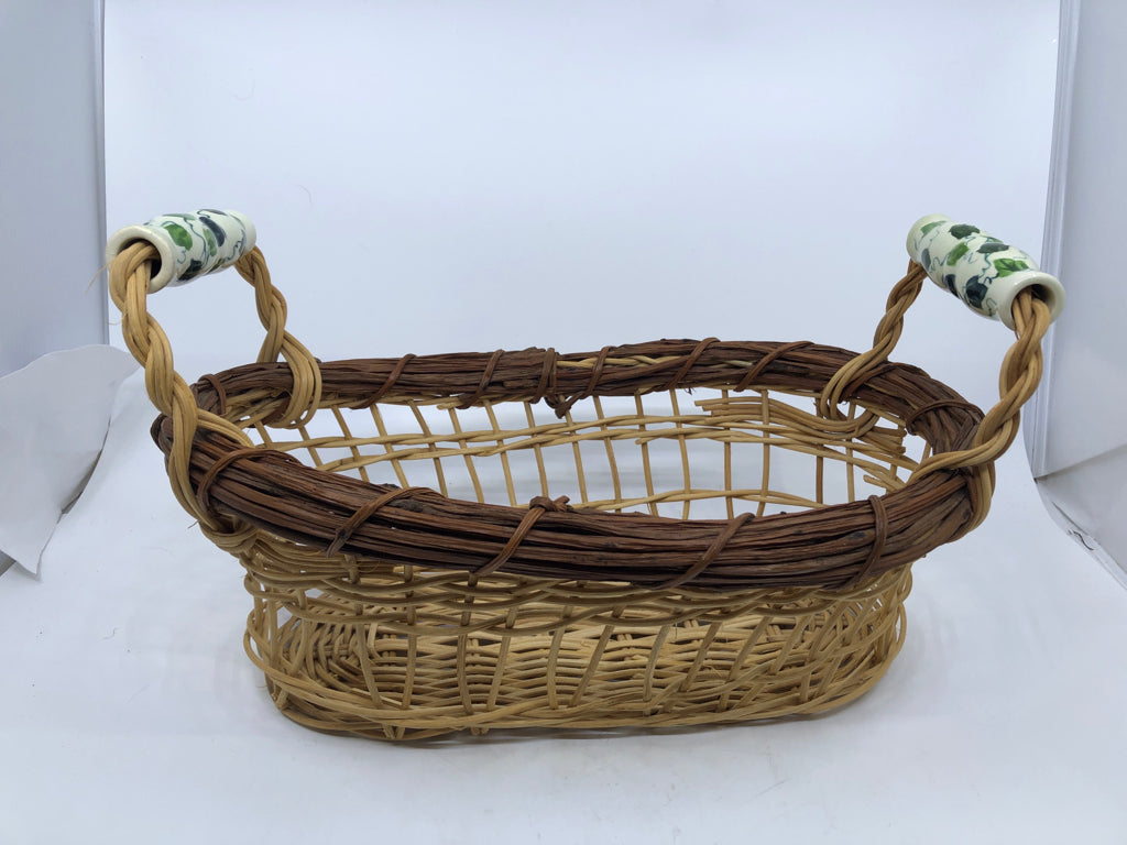 OVAL BASKET W/ CERAMIC HANDLES VINE PATTERN.