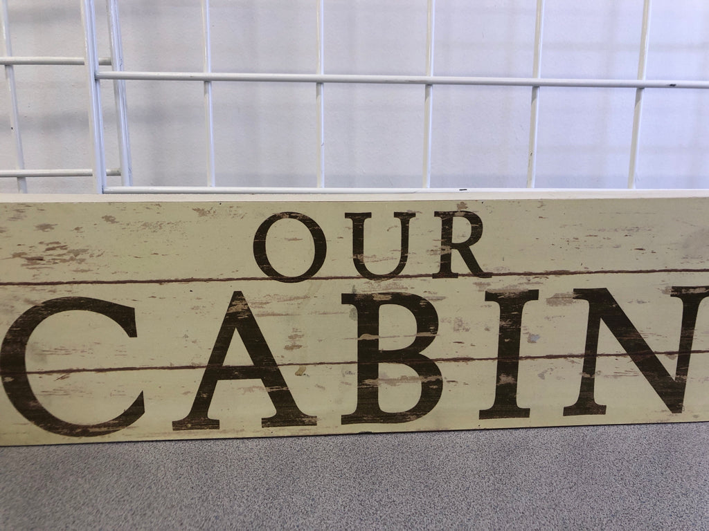 "OUR CABIN" CREAM DISTRESSED WOOD SIGN.