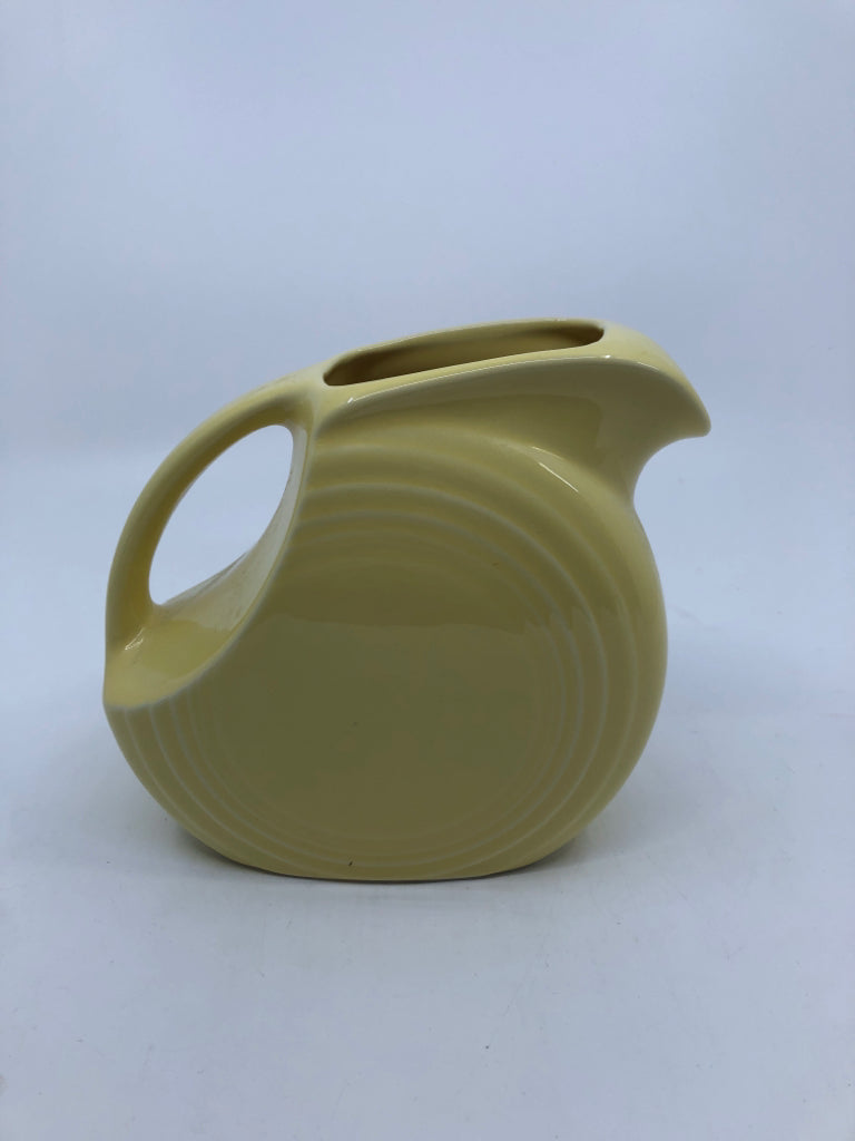 YELLOW FIESTA WARE DISC PITCHER W/HANDLE.