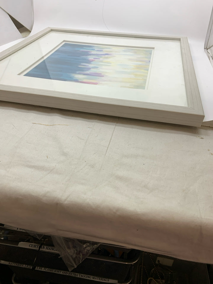 ABSTRACT BLUE YELLOW DRIPS IN WHITE FRAME.