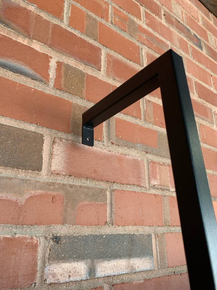 DARK FRAMED LADDER-STYLE WALL-MOUNT BOOKSHELF.