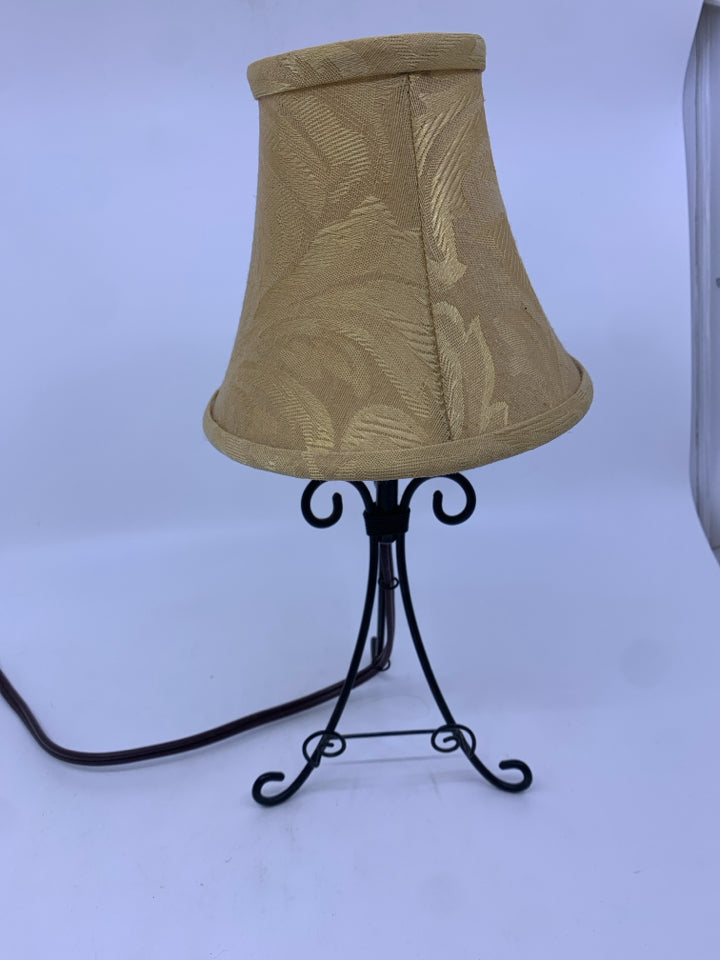 SMALL BLACK WROUGHT IRON TABLE LAMP WITH TAN SHADE.