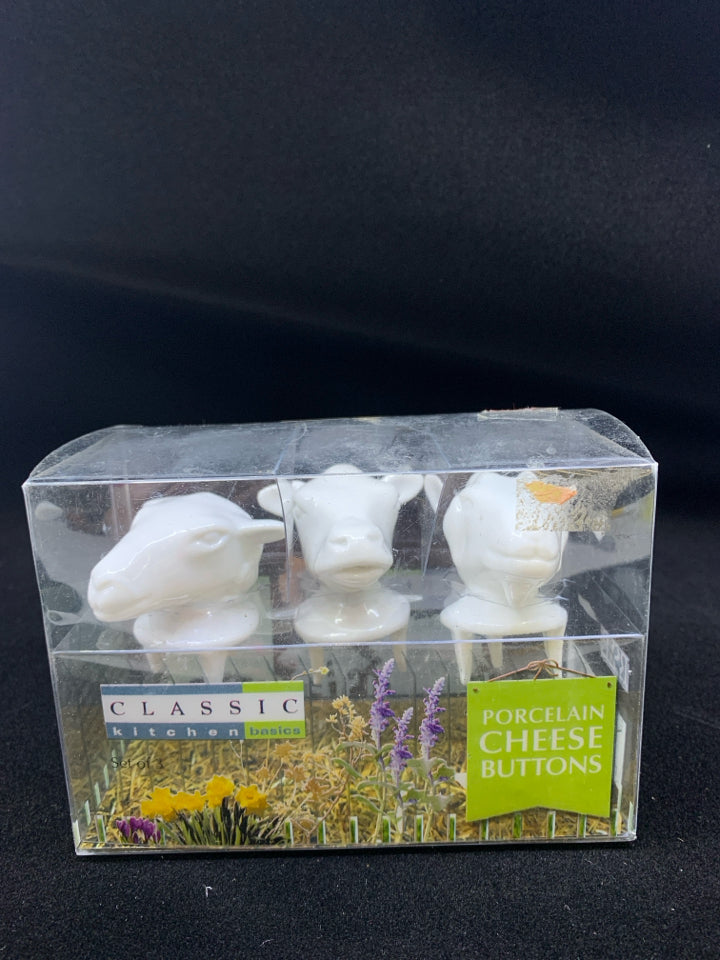 NIB COW PORCELAIN CHEESE BUTTONS.