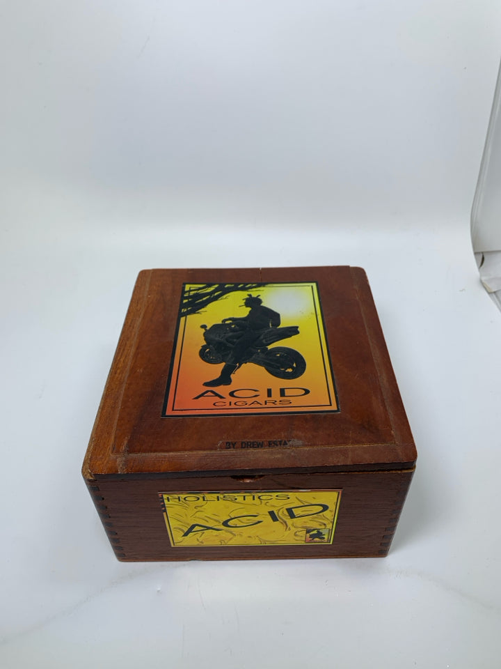 "ACID CIGARS" BOX MAN LEANING ON BIKE.
