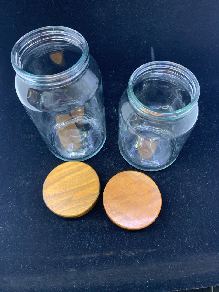 2 GLASS WOOD TOP CANISTERS.