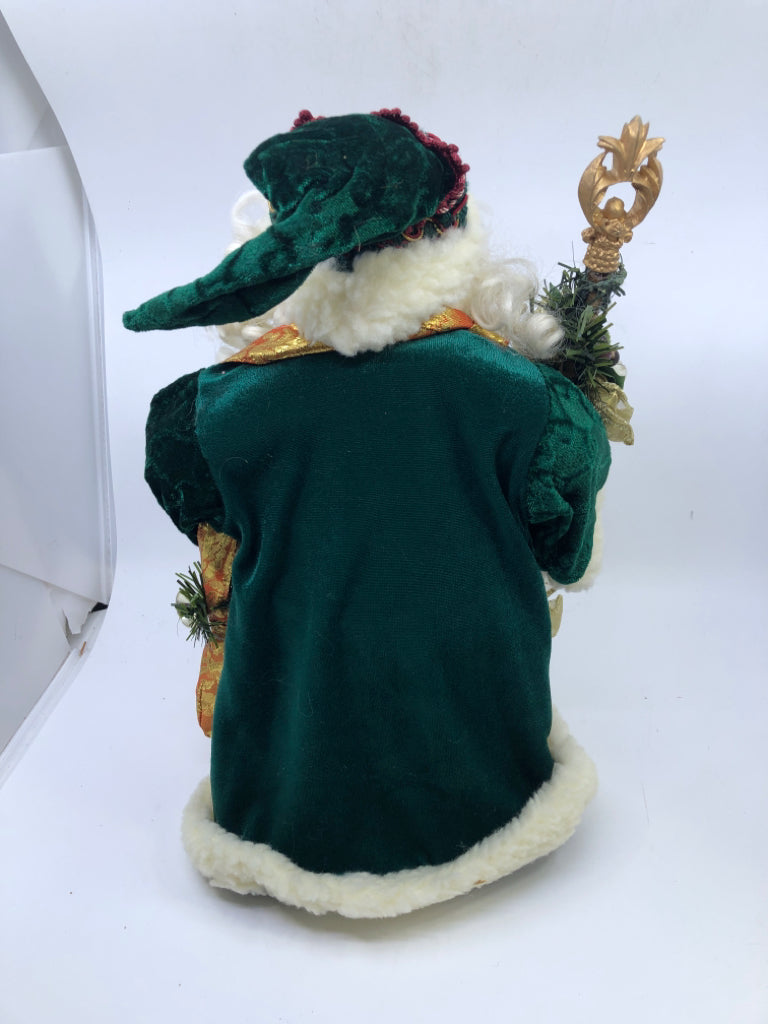 STANDING HOLLOW SANTA W/ DARK GREEN JACKET HOLDING STAKE.