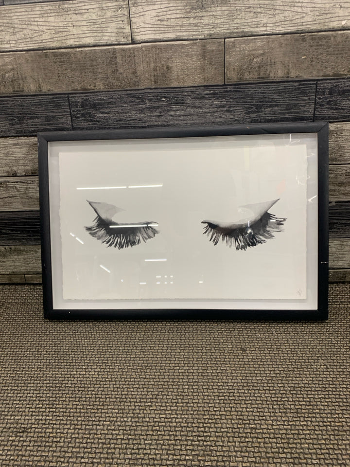 EYELASHES IN BLACK FRAME WALL HANGING.