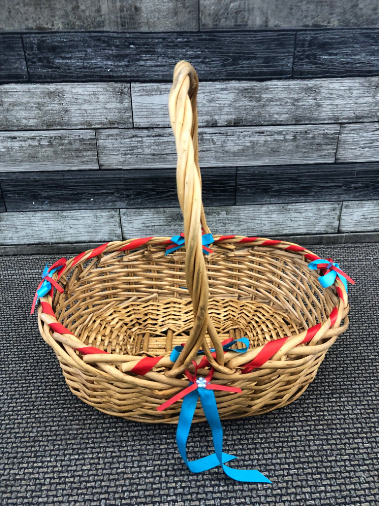 BLONDE WICKER BASKET W/BLUE AND RED BOWS.