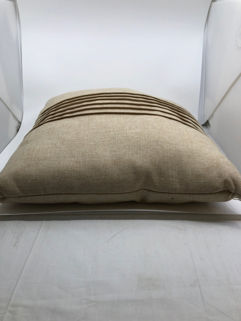 BEIGE PILLOW W/ PLEATS IN MIDDLE.