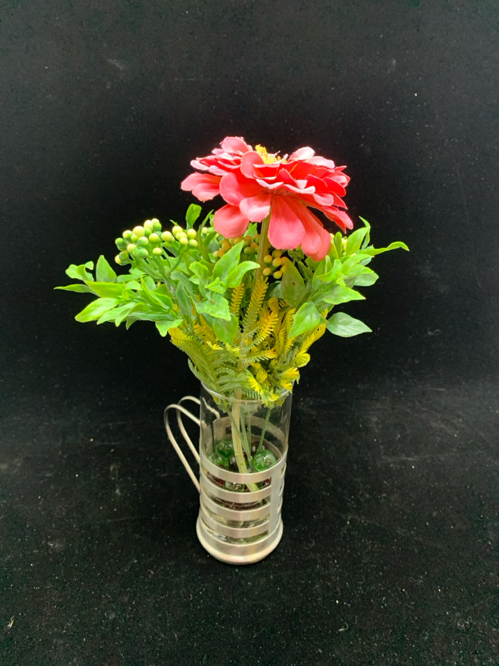 FAUX CARNATION IN GLASS AND SILVER MUG W/MARBLES.