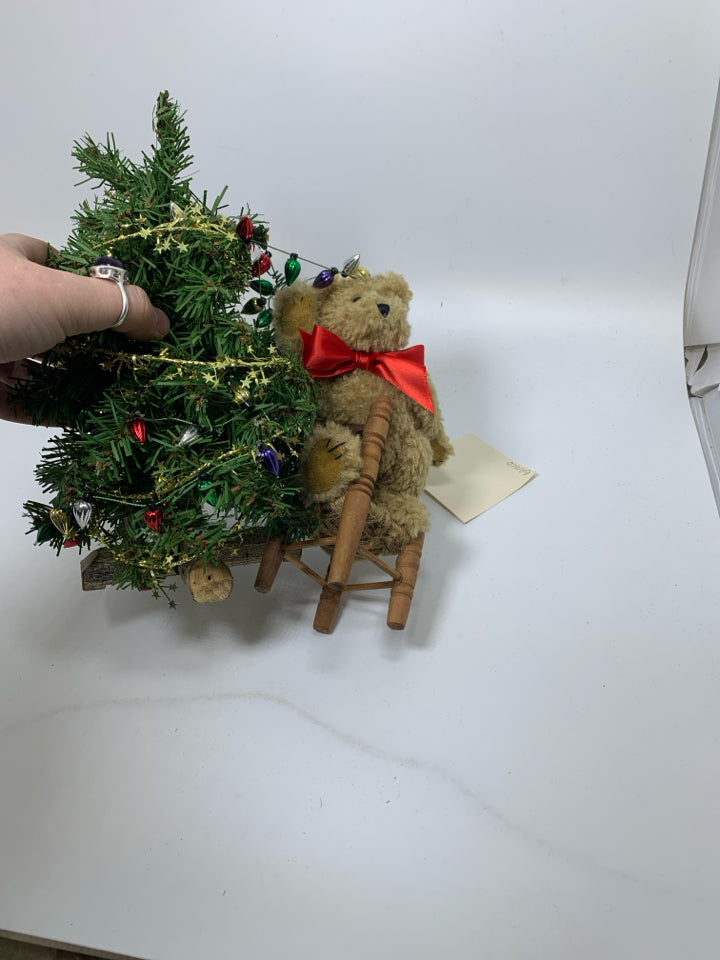 BOYDS BEAR SMALL BEAR PUTTING LIGHT ON TREE STANDING ON CHAIR.