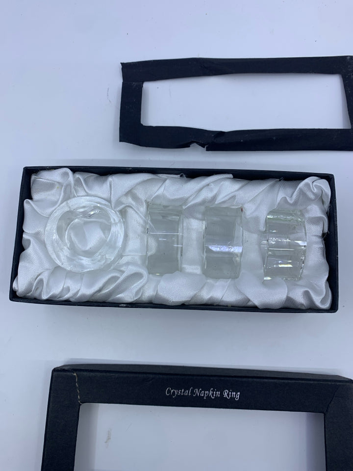 4 NIB CRYSTAL NAPKIN RINGS.