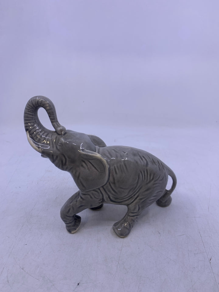 LIGHT GREY WALKING ELEPHANT W/ TRUNK UP.