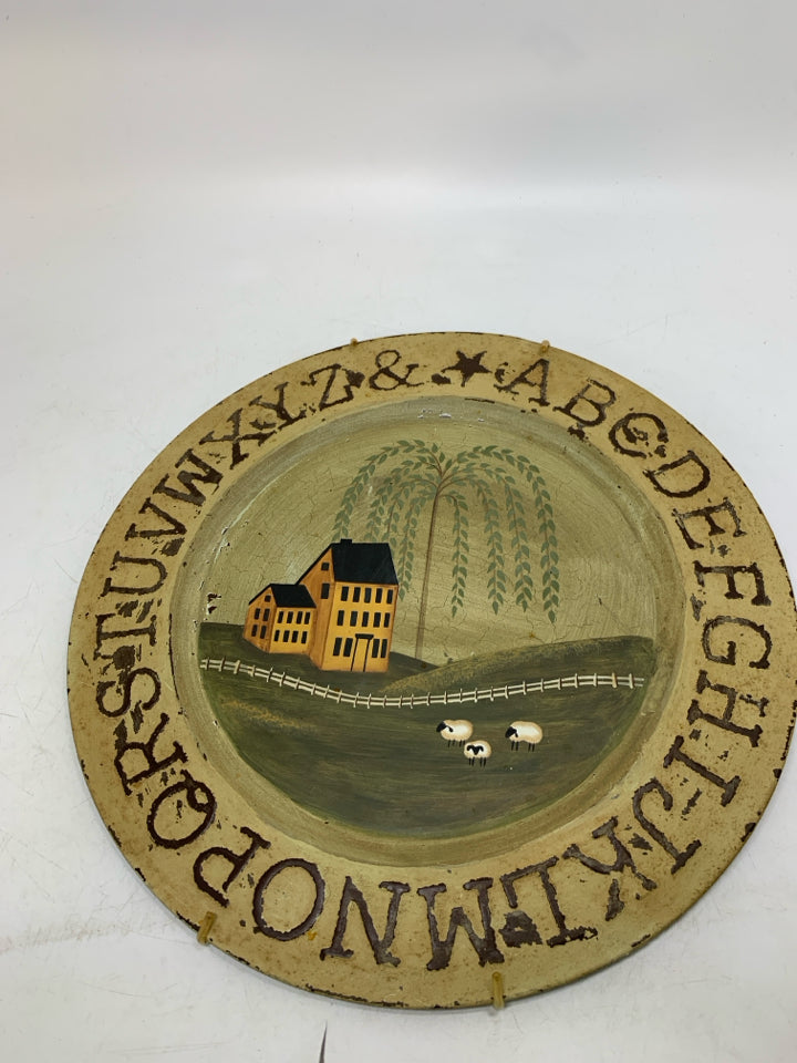 METAL CIRCLE WALL HANGING W/ YELLOW HOUSE/WEEPING WILLOW.