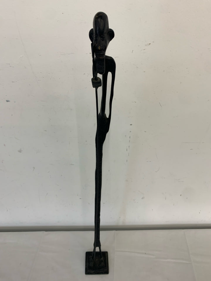 TALL BLACK METAL MAN FIGURE HOLDING A STAKE.