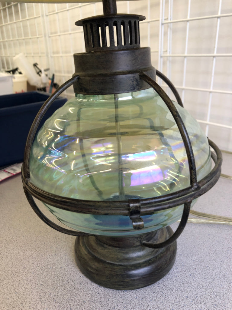 GREEN GLASS AND METAL BASE LAMP W/CREAM SHADE.