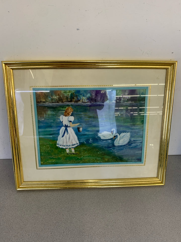 GIRL W/ BUCKET FEEDING SWANS WALL ART IN GOLD FRAME.