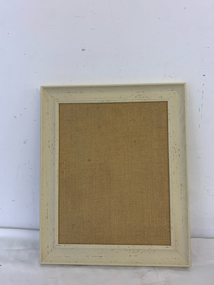 CREAM FRAMED CORK BOARD.