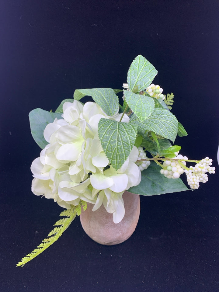 FAUX WHITE FLORAL AND GREENERY IN TERRA COTTA VASE.