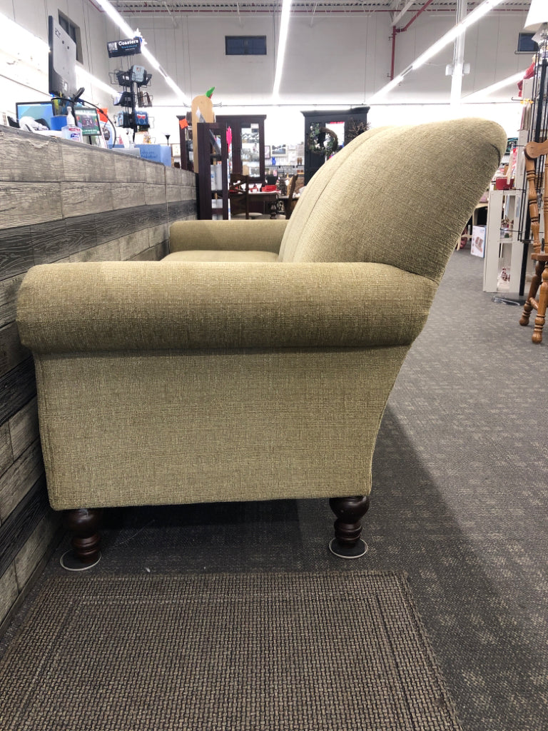 ARTICHOKE GREEN SOFA W/ BROWN WOOD LEGS.