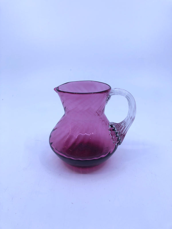 PINK BLOWN GLASS PITCHER W/ RIBBED DESIGN.