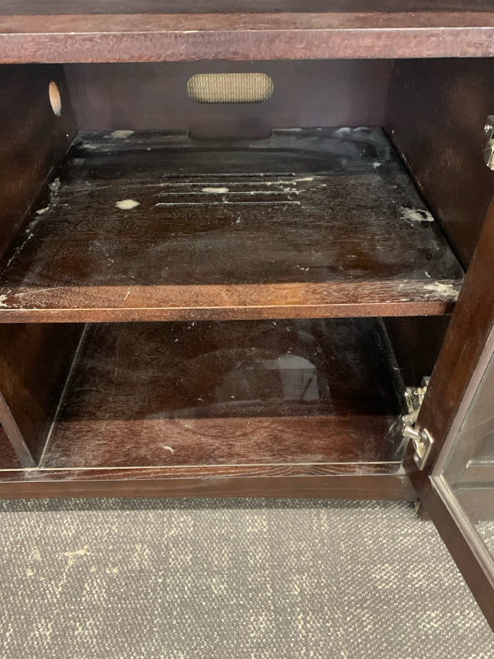 HEAVY DARK WOOD AND GLASS ENTERTAINMENT CENTER WITH SHELF AND CABINET STORAGE.