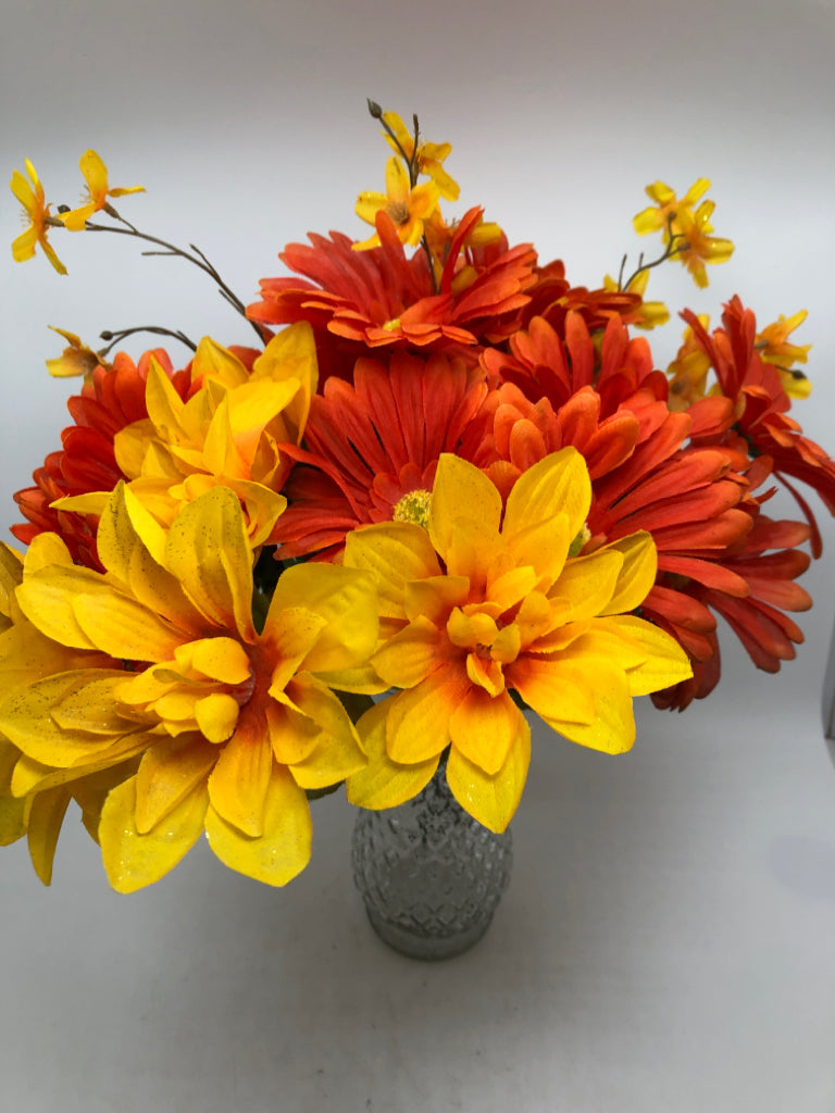 ORANGE FLORALS IN TEXTURED GLASS VASE.