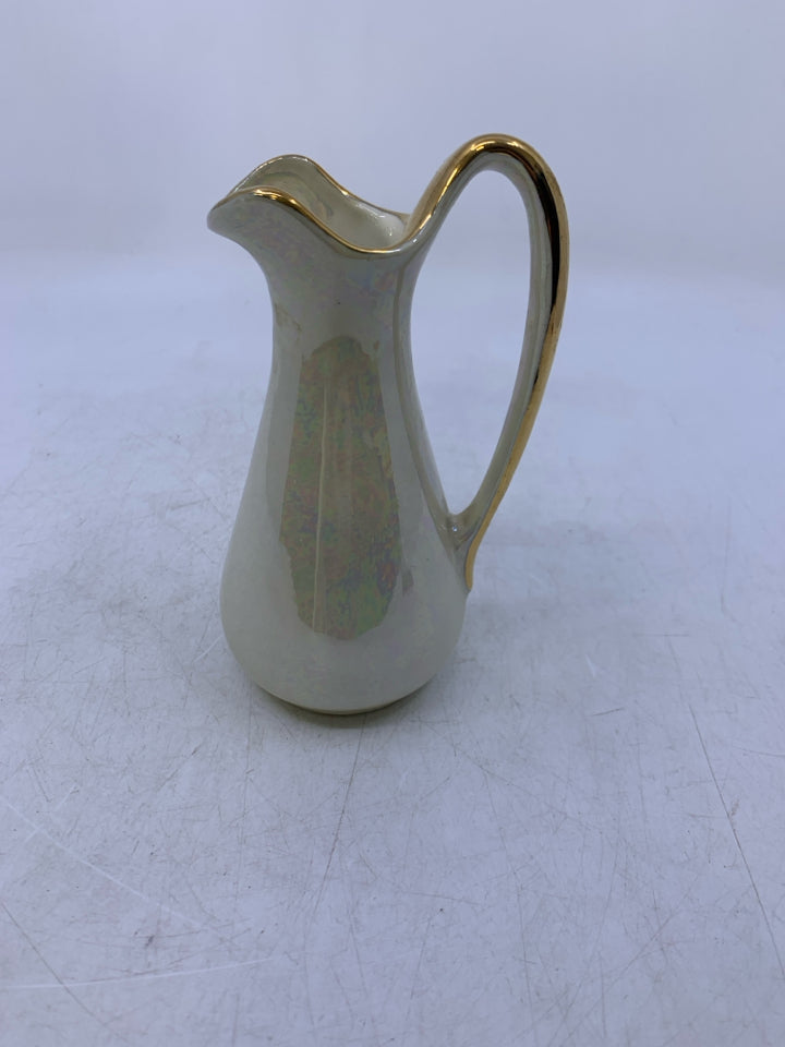 SMALL IVORY IRIDESCENT PITCHER W/ GOLD DETAILS.