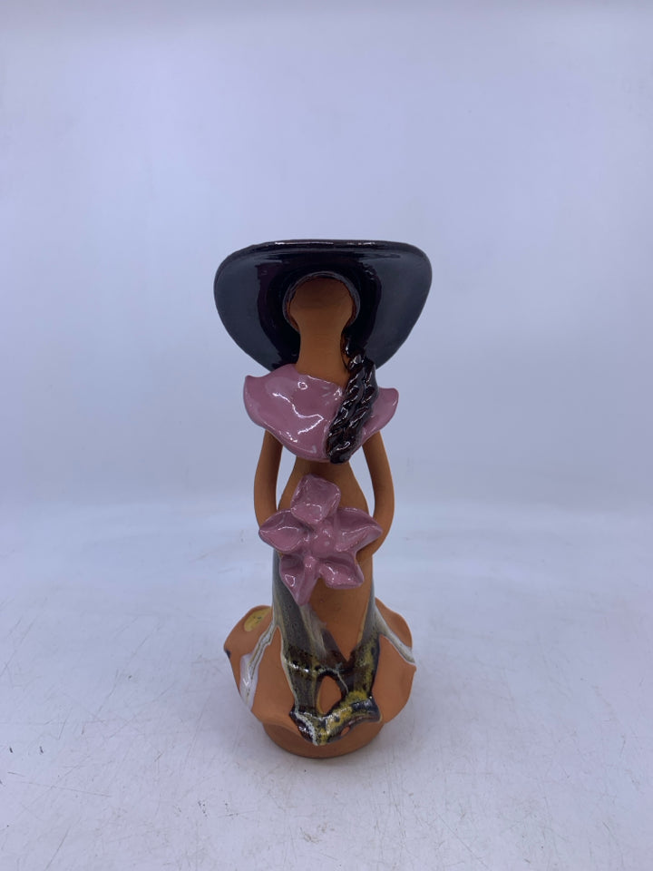 CLAY FACELESS WOMAN BROWN HAT HOLDING PINK FLOWERS.
