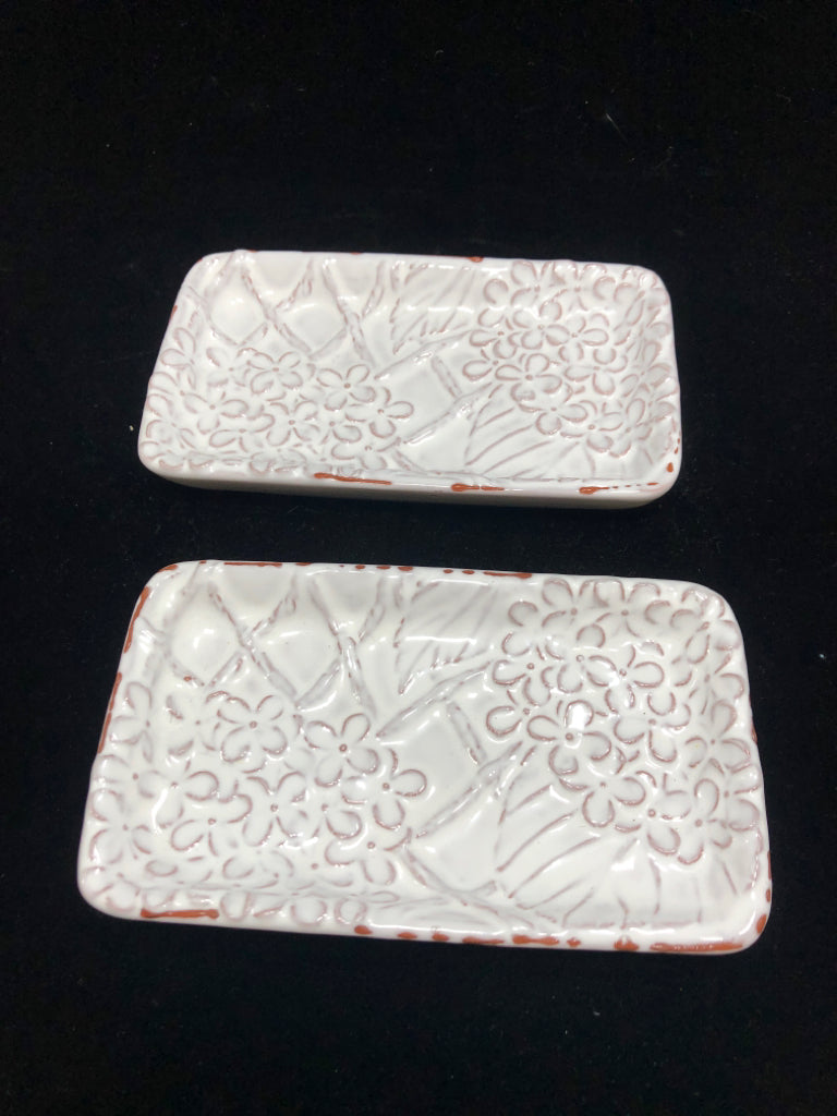 2 WHITE GLAZED CERAMIC TRAYS W/EMBOSSED FLOWERS.