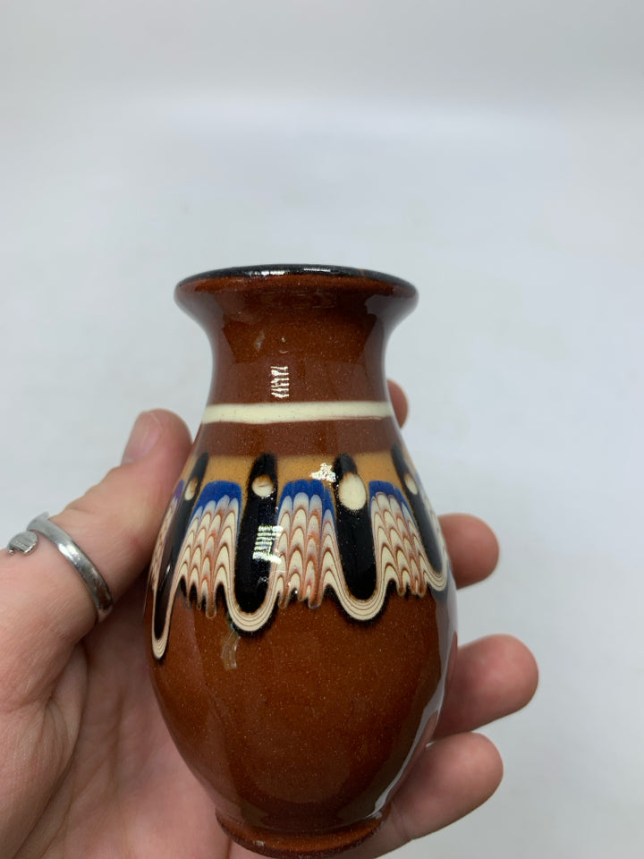 DARK BROWN TERRA COTTA BUD VASE W/ COLORFUL PATTERN.