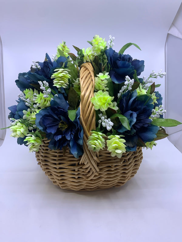 FAUX BLUE AND GREEN FLORAL IN WICKER BASKET.